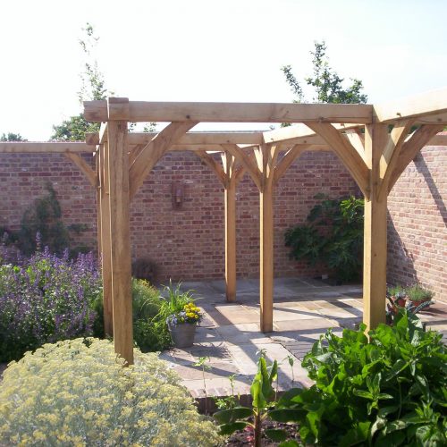 solid oak pergola structure in kitchen garden